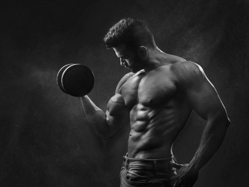 Muscular person lifting a dumbbell.