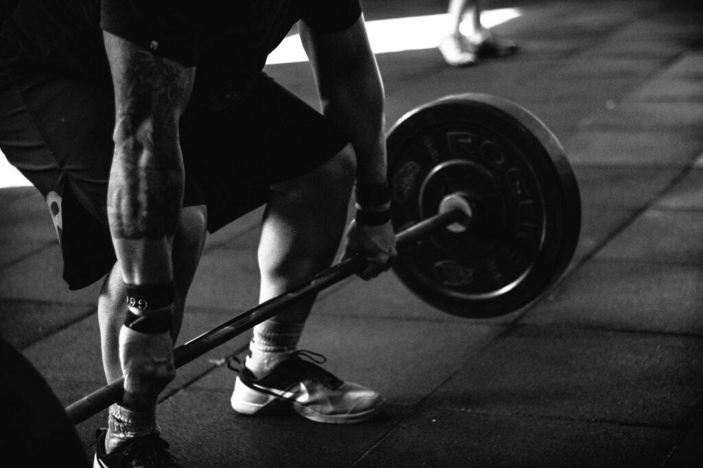 Muscular person lifting a dumbbell.